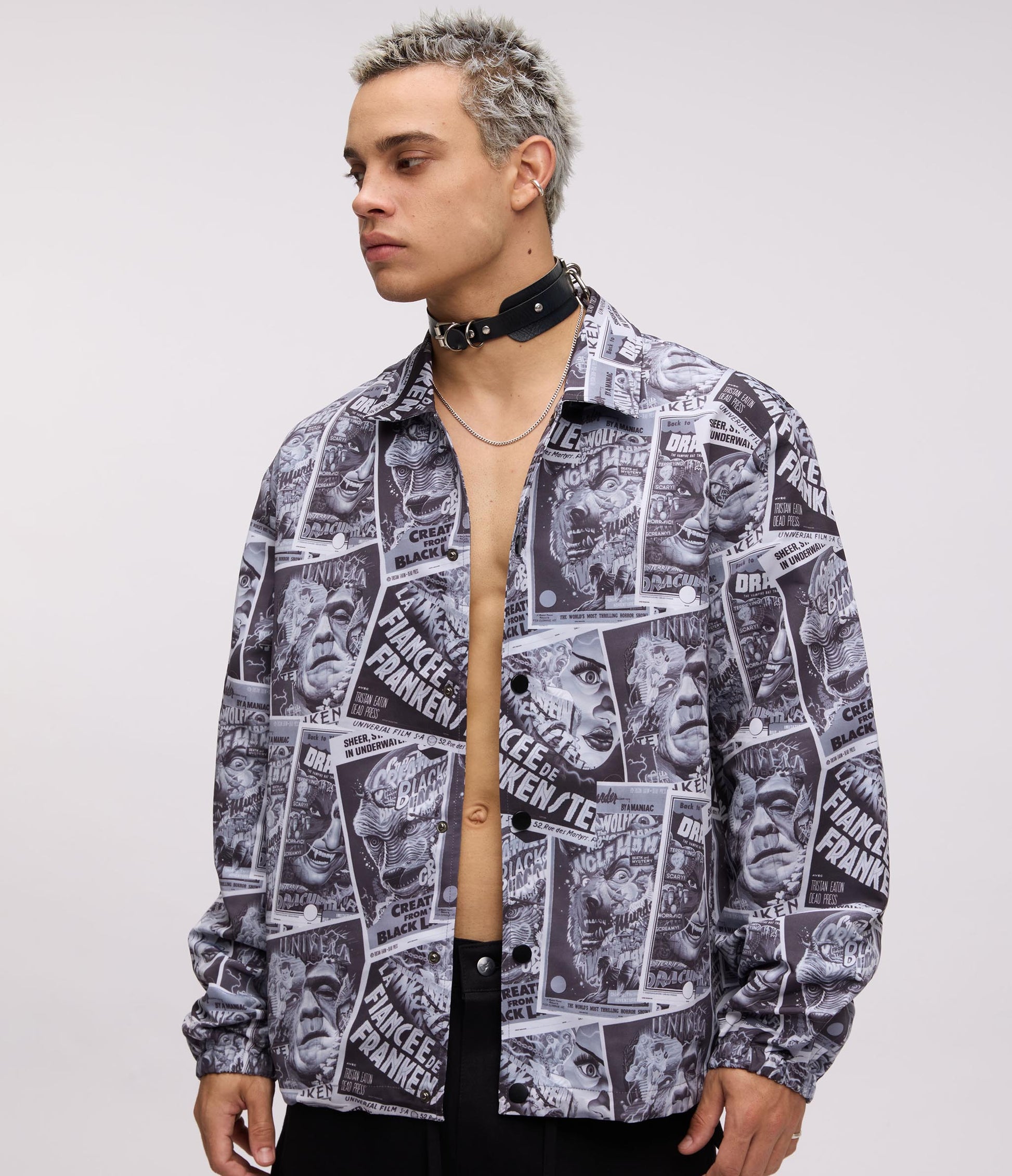 Person wearing a black and white patterned shirt with visible branding on a plain background